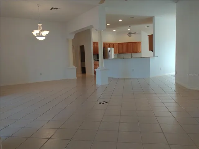 a kitchen with kitchen island a counter top space stainless steel appliances and a counter top space