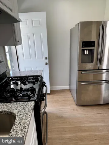 a kitchen with granite countertop a stove and a sink
