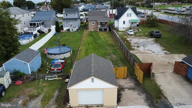 an aerial view of residential houses with outdoor space and swimming pool