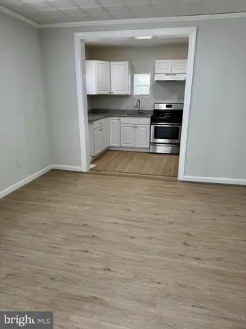 a kitchen with granite countertop a stove a refrigerator and a sink
