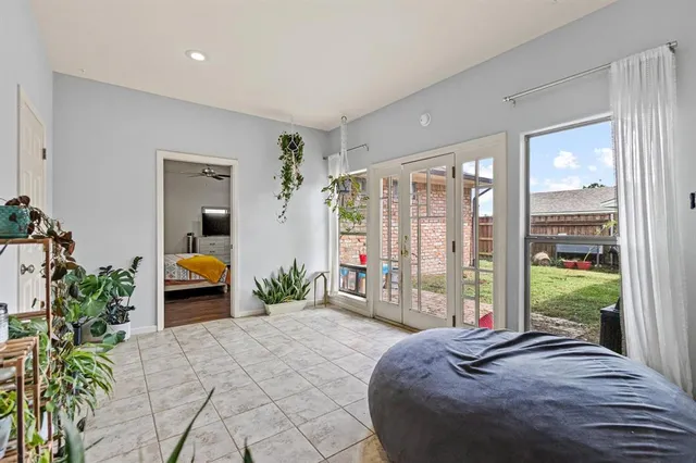 a spacious bedroom with a bed and large windows