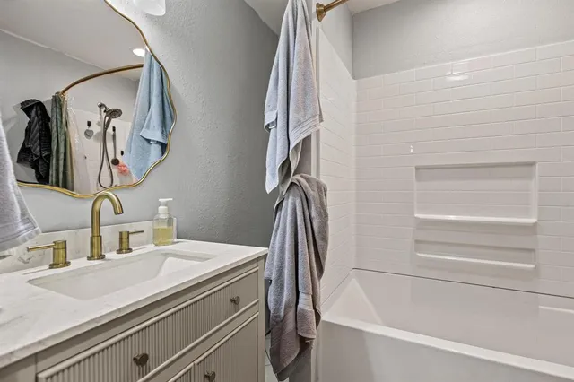 a bathroom with a sink a mirror and a bathtub