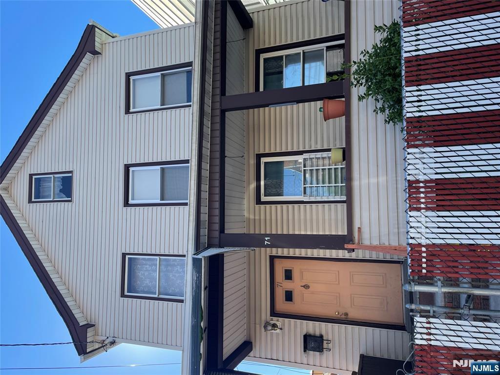 71 Passaic Street, Unit 2 Passaic, NJ 07055 - Photo 1 of 11 a front view of a house with a garden