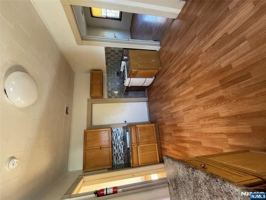 71 Passaic Street, Unit 2 Passaic, NJ 07055 - Photo 3 of 11 wooden floor in an empty room with a window