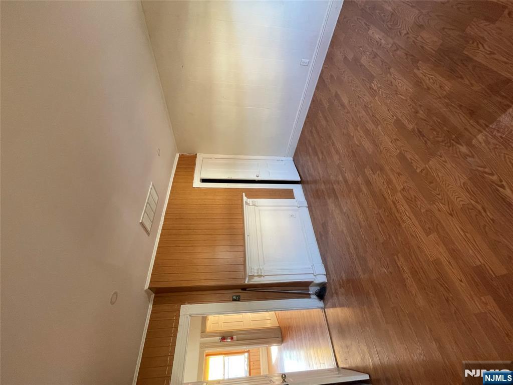 71 Passaic Street, Unit 2 Passaic, NJ 07055 - Photo 5 of 11 a view of an empty room with wooden floor