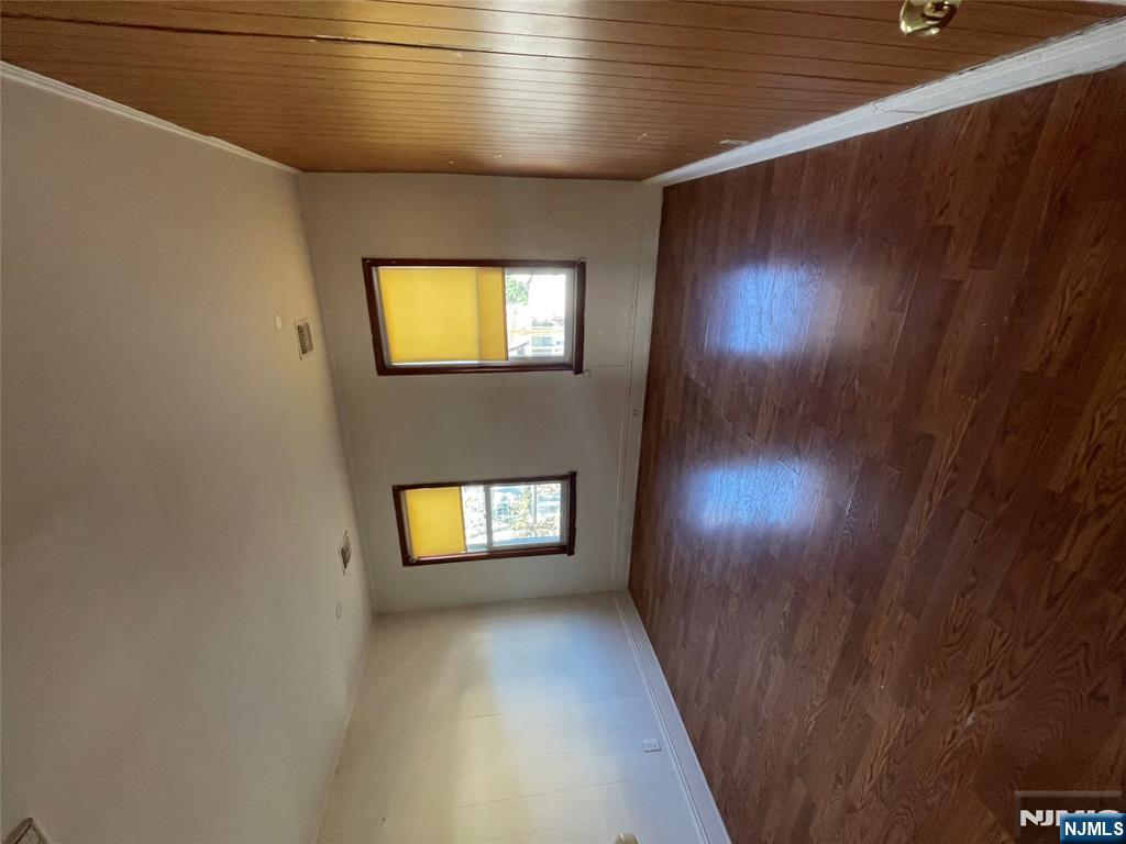 71 Passaic Street, Unit 2 Passaic, NJ 07055 - Photo 6 of 11 an empty room with wooden floor and windows