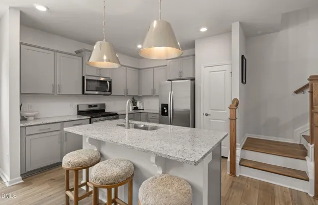 a large kitchen with a table and chairs