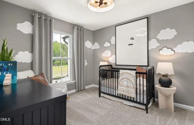 a bedroom with a large bed and a chandelier fan