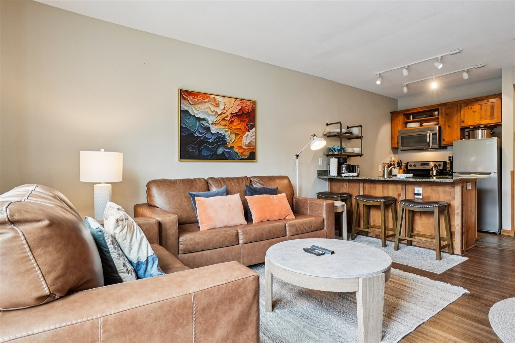 129 River Run Road, Unit 8055 Keystone, CO 80435 - Photo 6 of 50 Living area with dark wood finished floors and track lighting