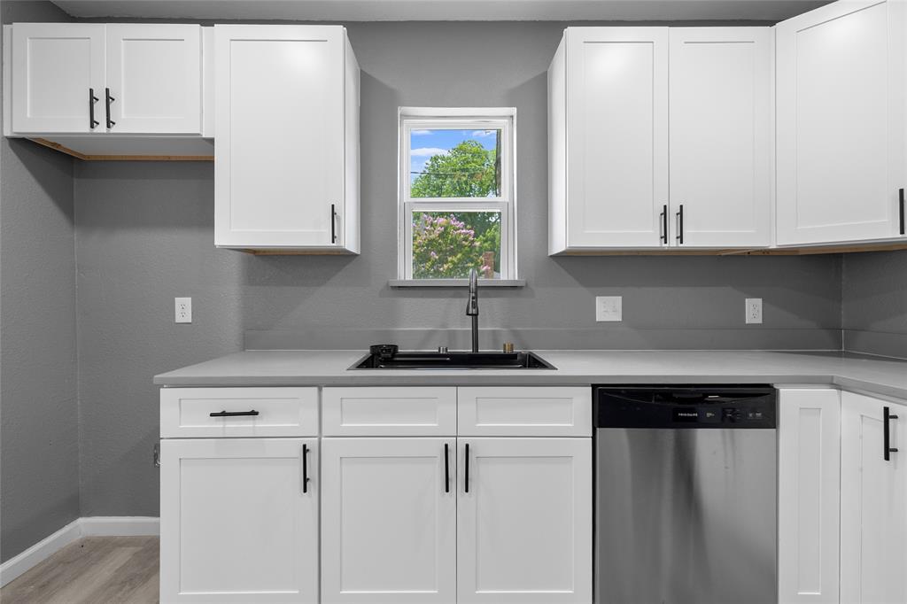 211 Southeast 7th Street Cooper, TX 75432 - Photo 11 of 29 a kitchen with white cabinets and a window