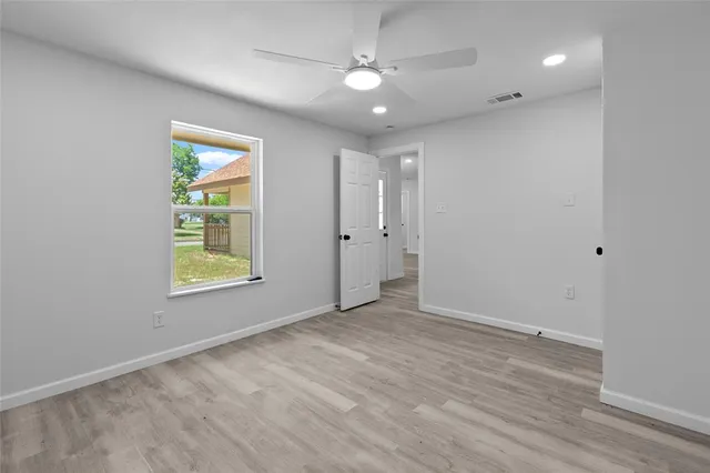 an empty room with windows and closet