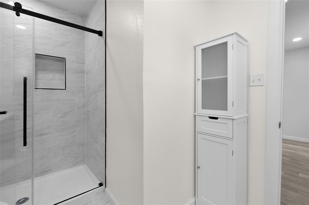 211 Southeast 7th Street Cooper, TX 75432 - Photo 15 of 29 a bathroom with a shower and a glass door