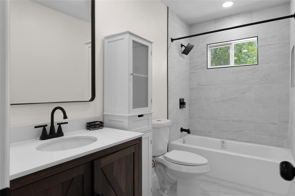 211 Southeast 7th Street Cooper, TX 75432 - Photo 16 of 29 a bathroom with a sink a toilet and shower