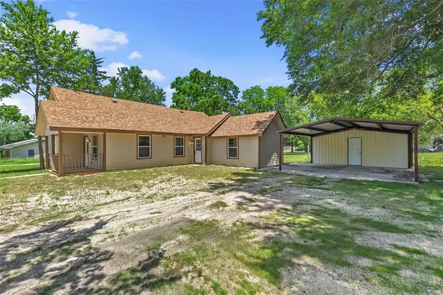 a view of a yard with a house and a tree