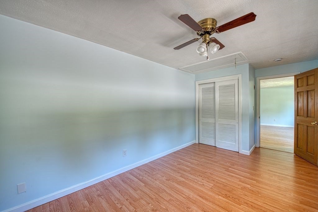 81 Errol Road Brockton, MA 02302 - Photo 26 of 31 an empty room with wooden floor fan and windows