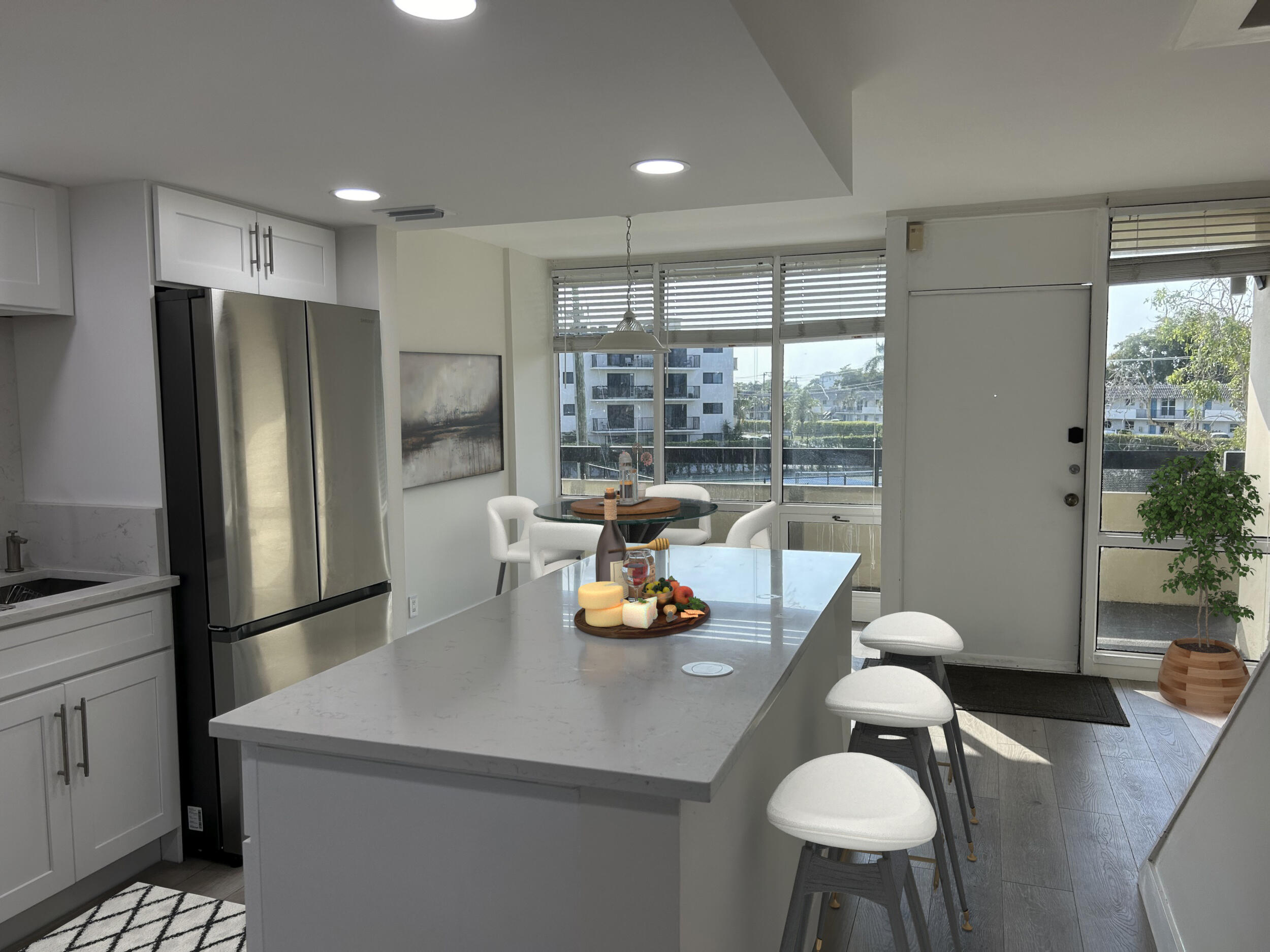 a kitchen with a table chairs refrigerator and a sink