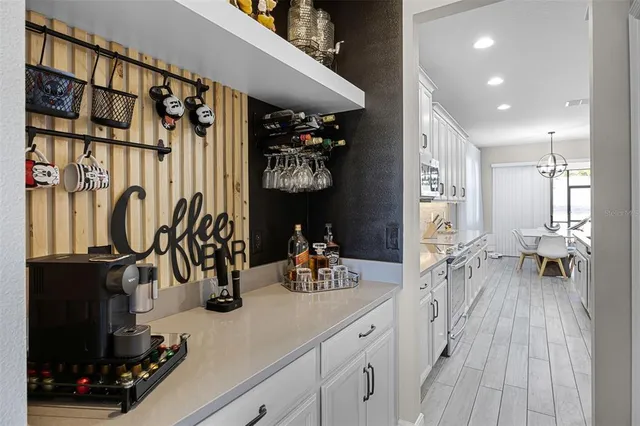 a hallway with a view of living room with wooden floor
