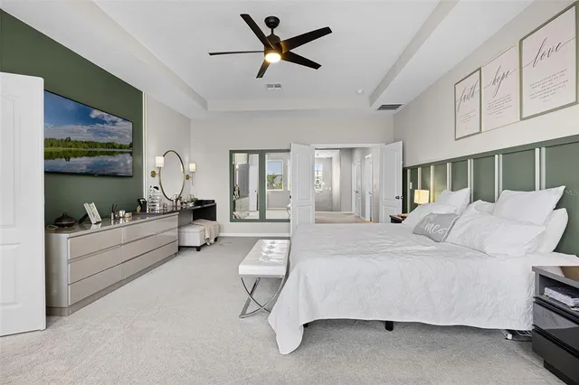 a living room with furniture ceiling fan and a rug