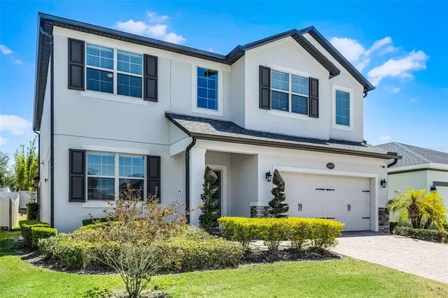 a front view of a house with a yard and porch