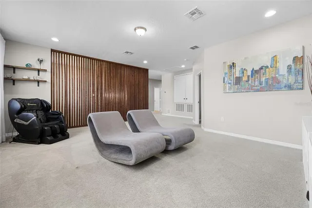 a living room with furniture a lamp and a potted plant