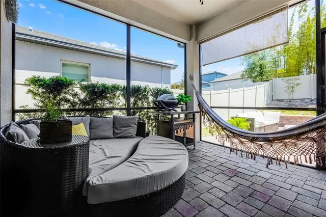 a view of a house with swimming pool and sitting area