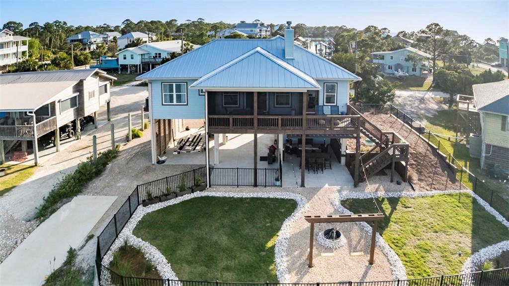an aerial view of a house with swimming pool and furniture