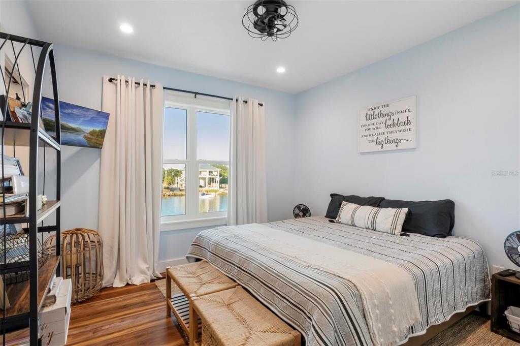 331 Land Street Eastpoint, FL 32328 - Photo 12 of 36 a bedroom with a bed lamps and a large mirror