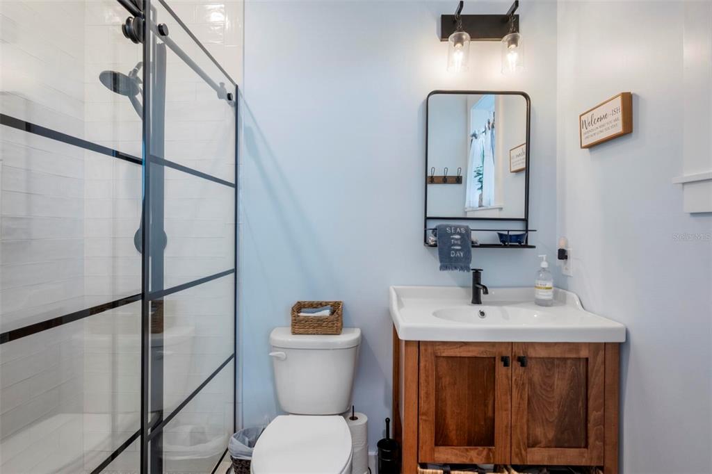 331 Land Street Eastpoint, FL 32328 - Photo 13 of 36 a bathroom with a toilet a sink and mirror