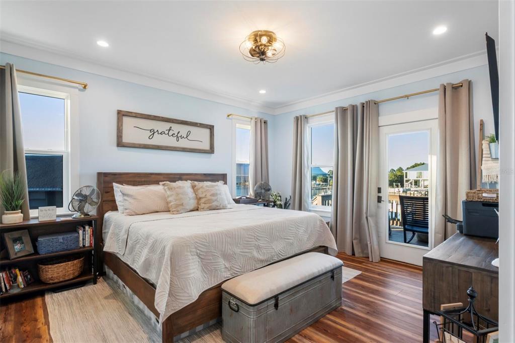 331 Land Street Eastpoint, FL 32328 - Photo 15 of 36 a bedroom with a bed and wooden floor