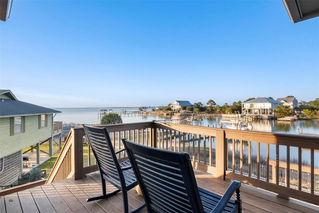 331 Land Street Eastpoint, FL 32328 - Photo 19 of 36 a view of a balcony with wooden chairs