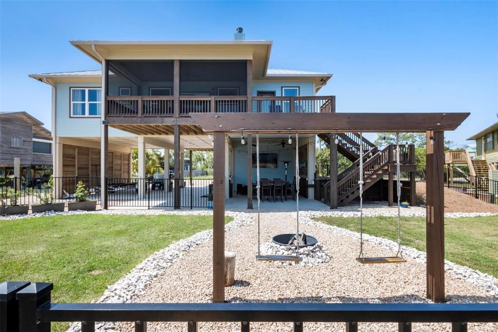 331 Land Street Eastpoint, FL 32328 - Photo 21 of 36 a view of a house with backyard porch and sitting area