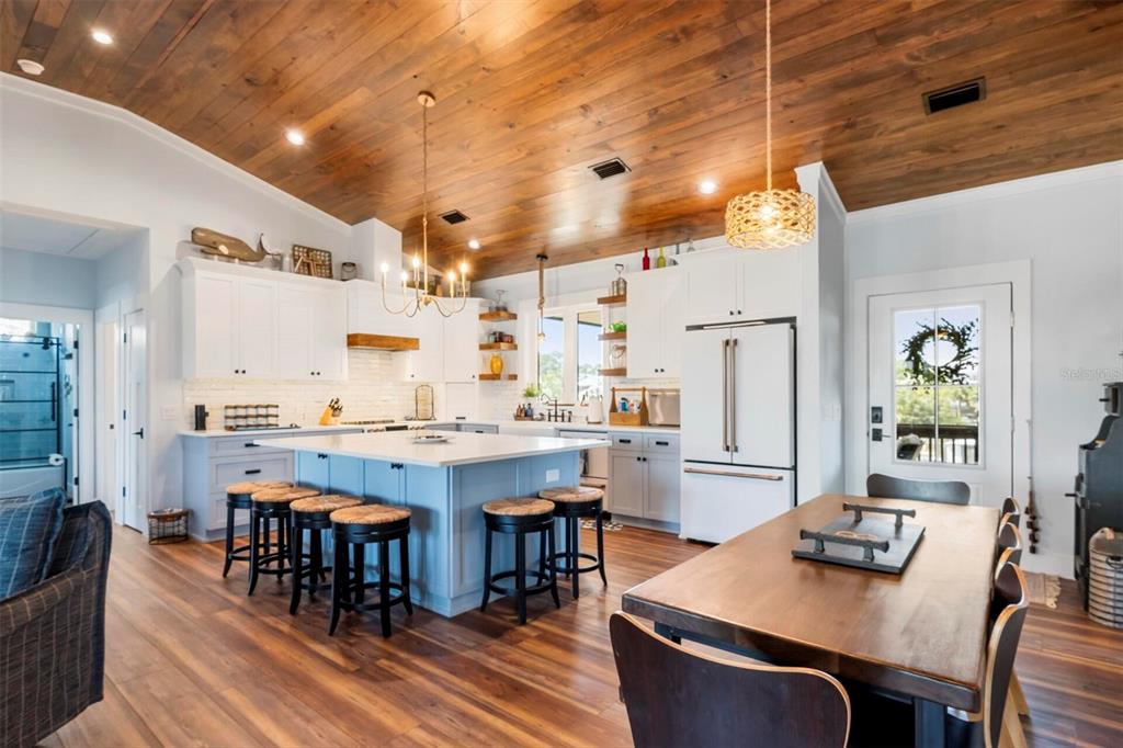 331 Land Street Eastpoint, FL 32328 - Photo 24 of 36 a dining hall with stainless steel appliances granite countertop a dining table and chairs with wooden floor