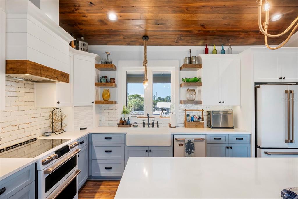 331 Land Street Eastpoint, FL 32328 - Photo 26 of 36 a kitchen with stainless steel appliances a stove a sink and a refrigerator
