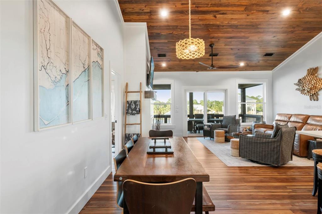 331 Land Street Eastpoint, FL 32328 - Photo 7 of 36 a dining room with wooden floor and large windows