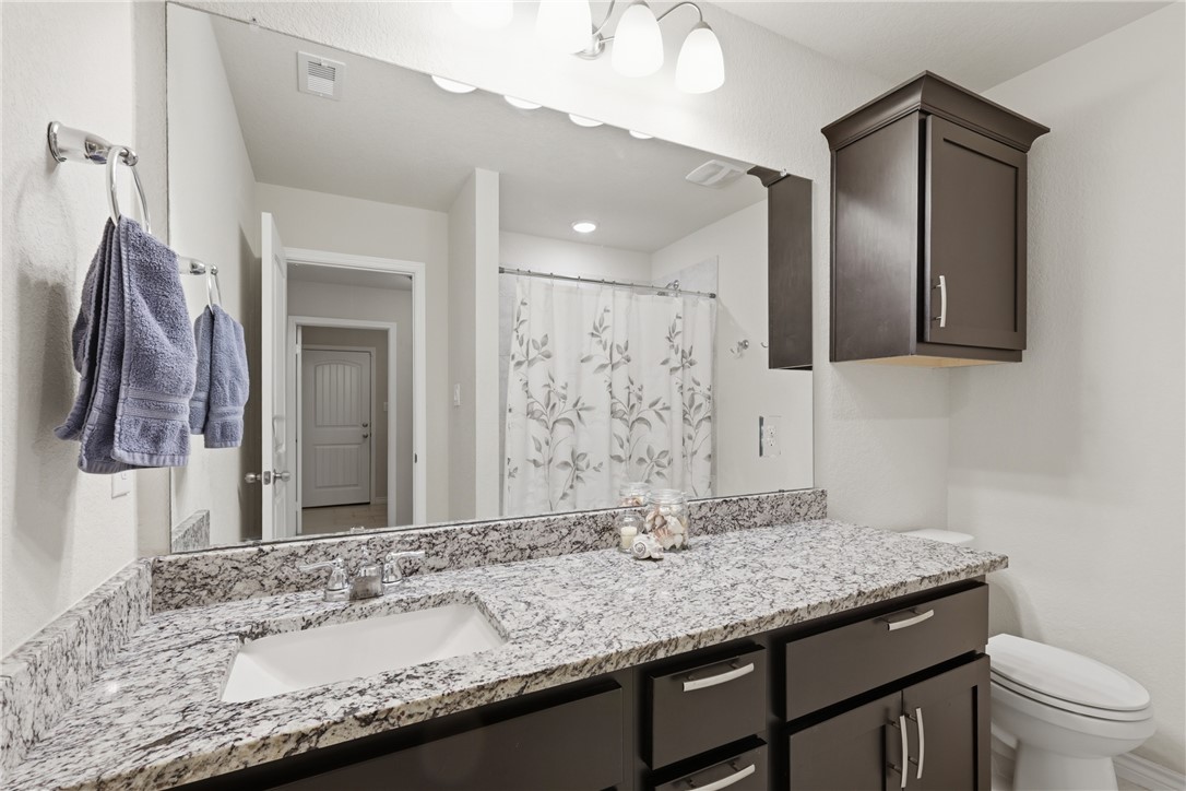 1943 Thorndyke Lane Bryan, TX 77807 - Photo 17 of 28 Hall bathroom featuring granite countertops, an extra wide vanity top and tons of storage!