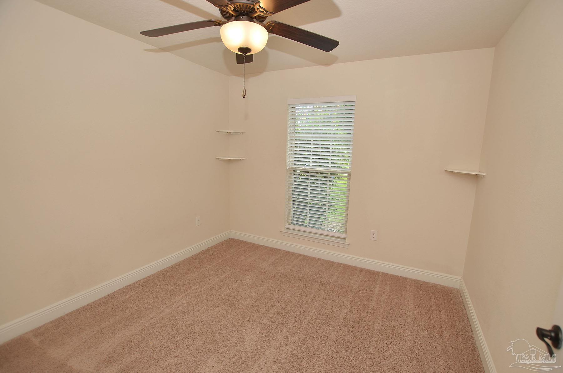 5709 Mill Stream Way Pace, FL 32571 - Photo 37 of 48 an empty room with a window and a fan