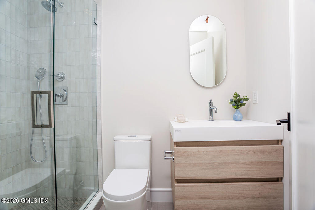 49 Salisbury Road Darien, CT 06820 - Photo 21 of 40 a bathroom with a sink toilet and a mirror