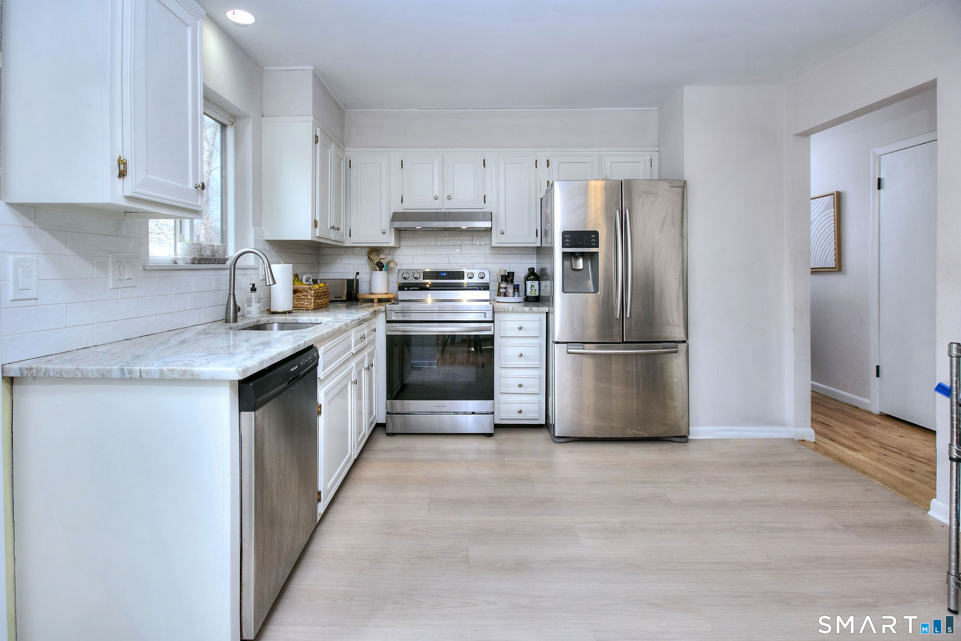 518 Bennetts Farm Road Ridgefield, CT 06877 - Photo 3 of 32 a kitchen with stainless steel appliances granite countertop a stove top oven a refrigerator and white cabinets