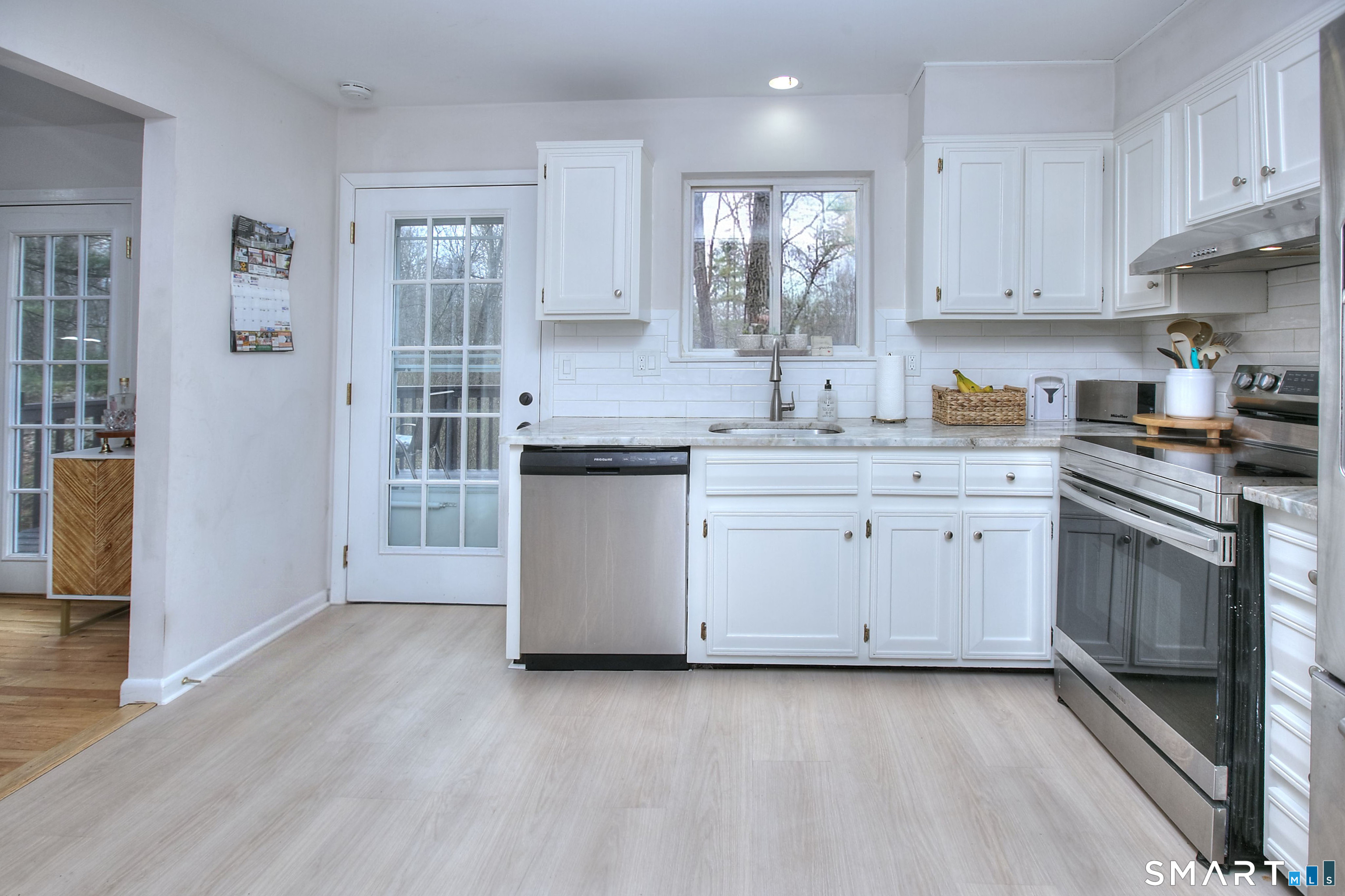 518 Bennetts Farm Road Ridgefield, CT 06877 - Photo 4 of 32 a kitchen with a sink stove cabinets and wooden floor