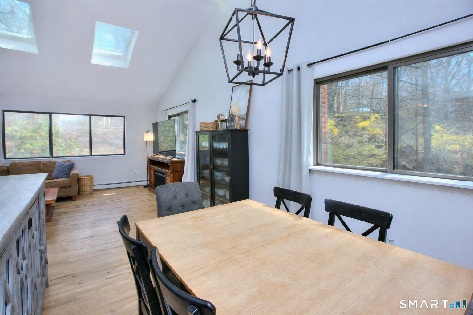 518 Bennetts Farm Road Ridgefield, CT 06877 - Photo 6 of 32 a large bedroom with wooden floor a chandelier a wooden table and chairs