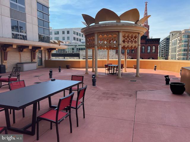 777 7th Street Northwest, Unit 930 Washington, DC 20001 - Photo 25 of 34 a view of a patio with a dining table and chairs