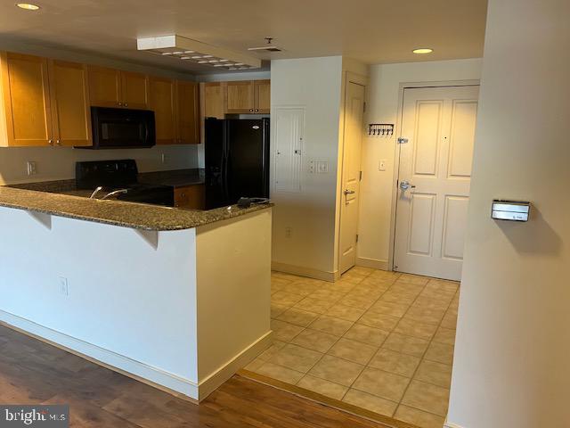 777 7th Street Northwest, Unit 930 Washington, DC 20001 - Photo 3 of 34 a kitchen with granite countertop a sink and a refrigerator