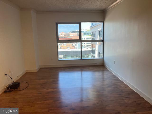 777 7th Street Northwest, Unit 930 Washington, DC 20001 - Photo 5 of 34 wooden floor in an empty room with a window