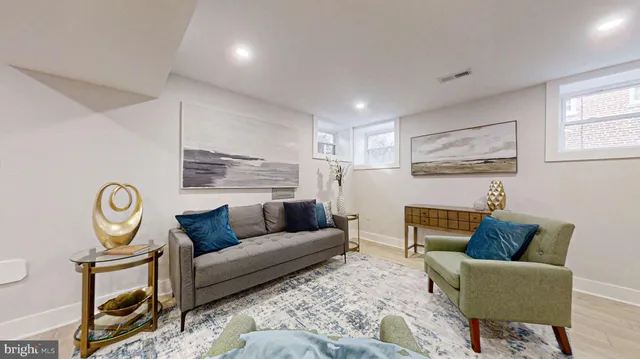 a living room with furniture fireplace and window