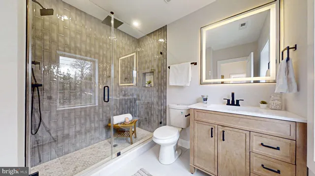 a spacious bathroom with a shower sink and mirror