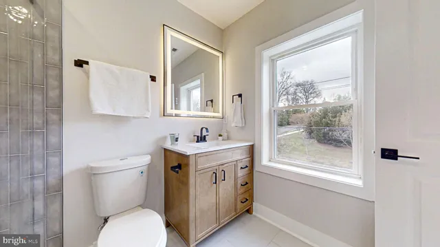 a bedroom with a bed and painting on the wall