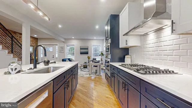 a kitchen with stainless steel appliances granite countertop a stove and a refrigerator