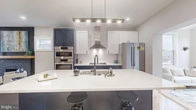 a living room with furniture a flat screen tv and a stove