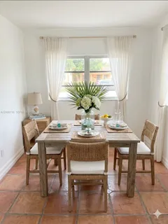 a view of a dining room with furniture and window
