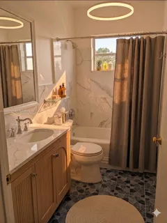 a bathroom with a sink toilet and shower